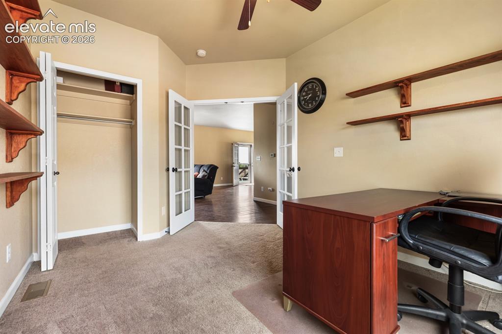 Image 10 of 50: Versatile room featuring light beige wall paint, carpet flooring, a bifold