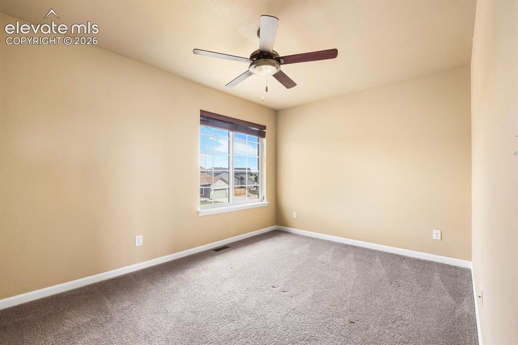 Image 31 of 50: Carpeted interior space featuring a large window with white trim, a ceiling