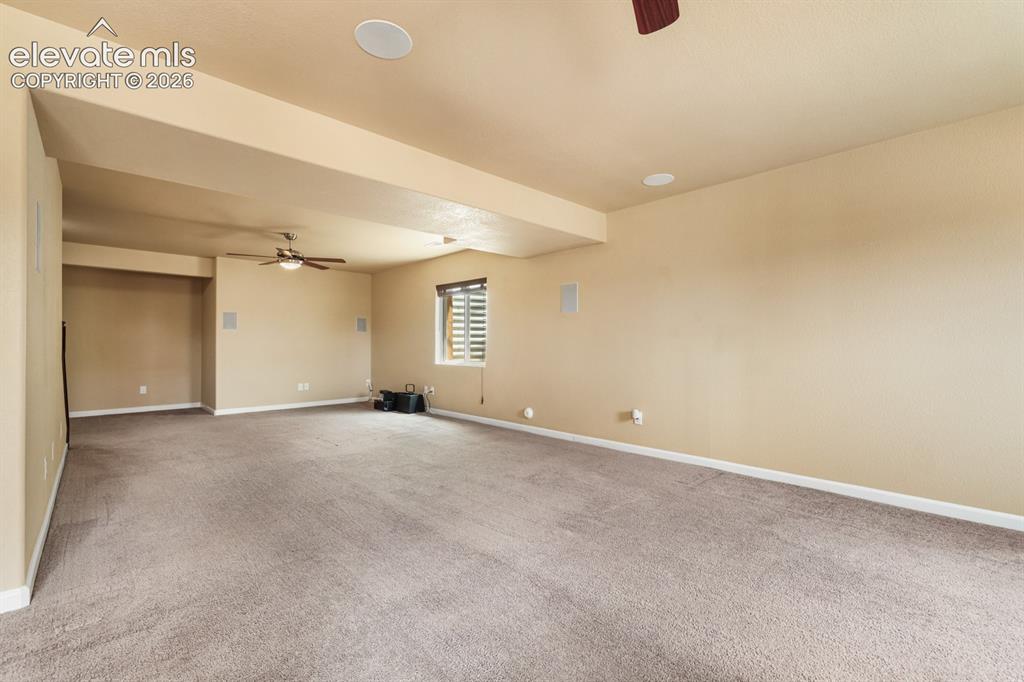 Image 36 of 50: Spacious room featuring neutral carpeting, a ceiling fan, recessed ceiling