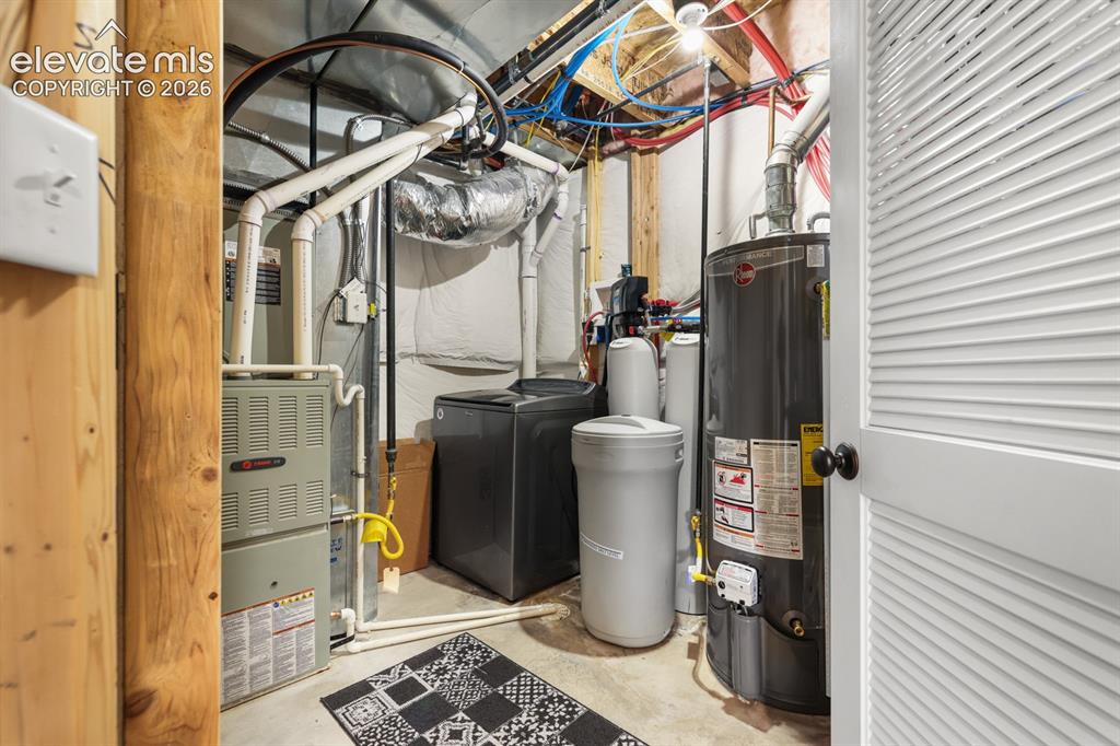 Image 42 of 50: Dedicated utility space featuring a water heater, furnace, and water condit