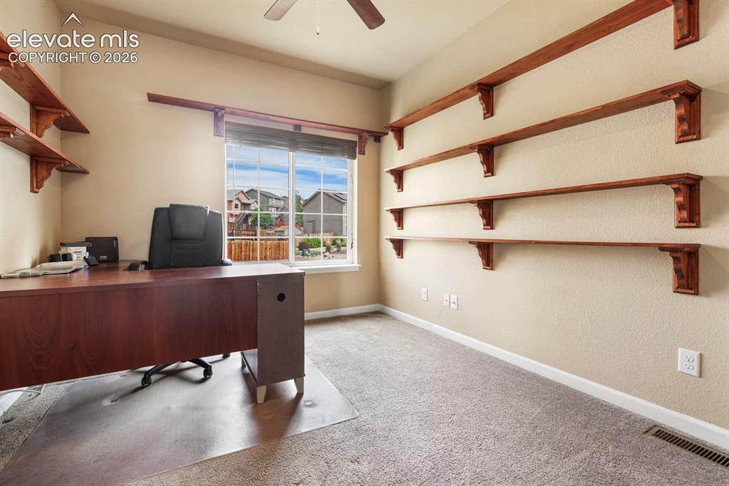 Image 9 of 50: Interior room featuring light beige walls and a window with white grids