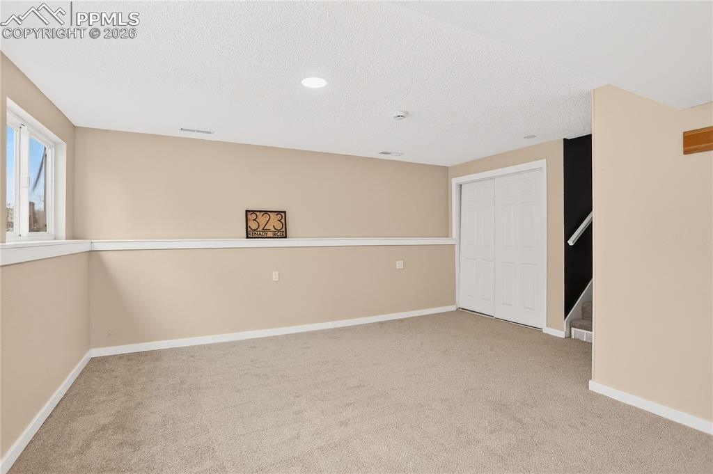 Image 17 of 37: Spacious lower level flex area with closet storage.
