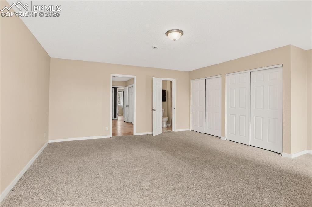 Image 23 of 37: Spacious primary bedroom with generous closet space.