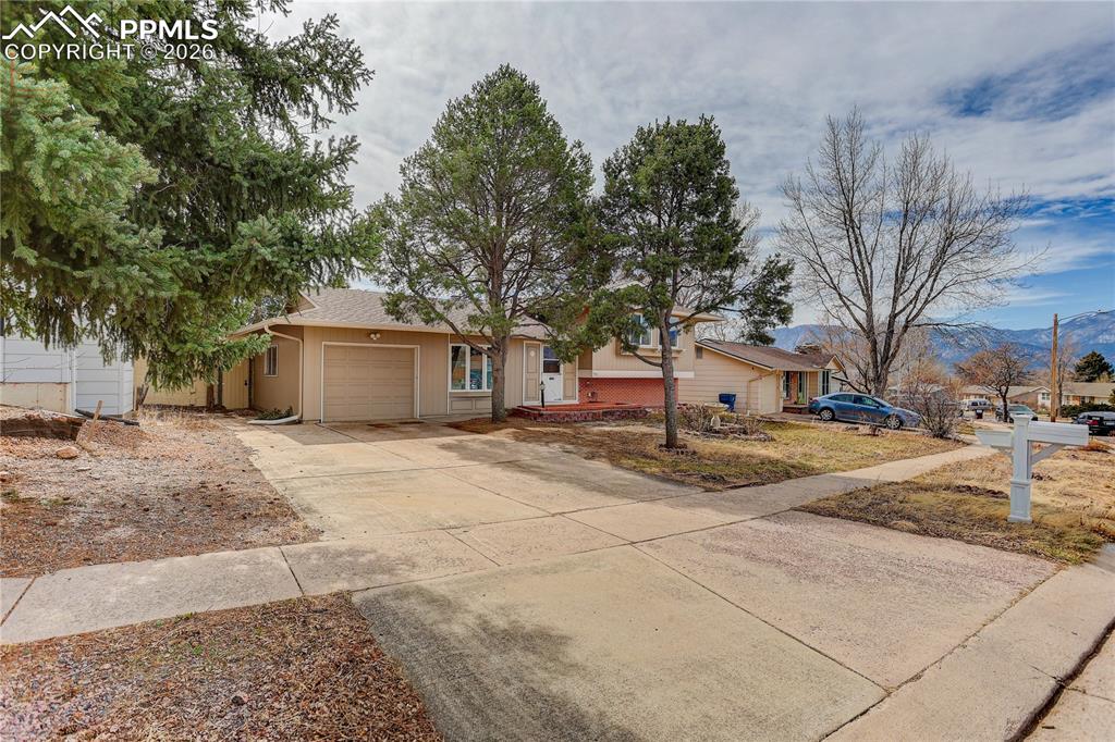 Image 3 of 37: Single story home featuring concrete driveway, an attached garage, and a mo