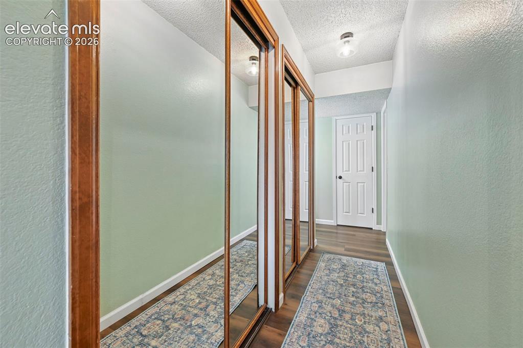 Image 24 of 48: Primary closet and hall leading to bathroom