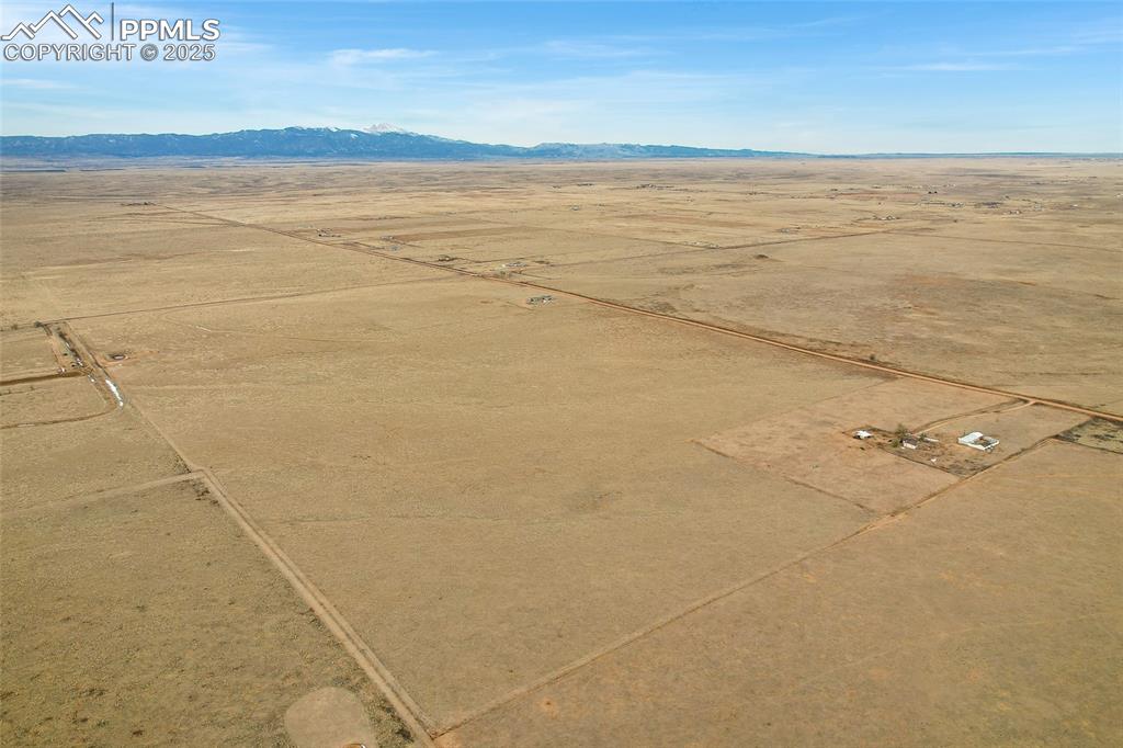 Image 5 of 7: View of rural area featuring a desert landscape and a mountainous backgroun