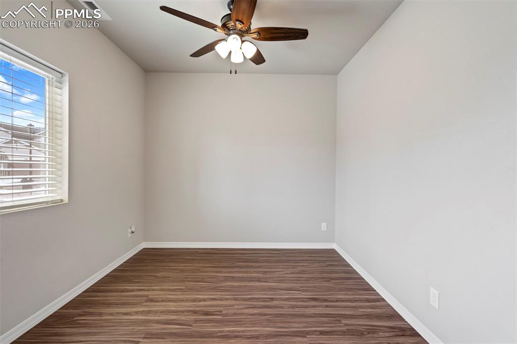 Image 16 of 46: Neutral wall paint complemented by wood-finish flooring