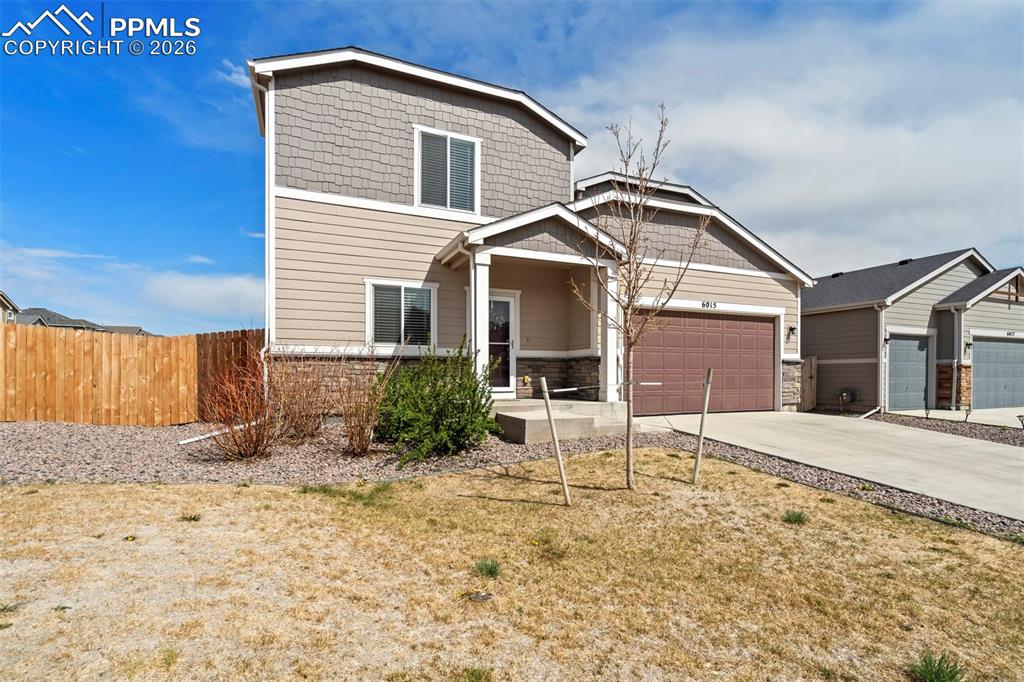 Image 2 of 46: Two-story residence featuring composite siding and shake accents