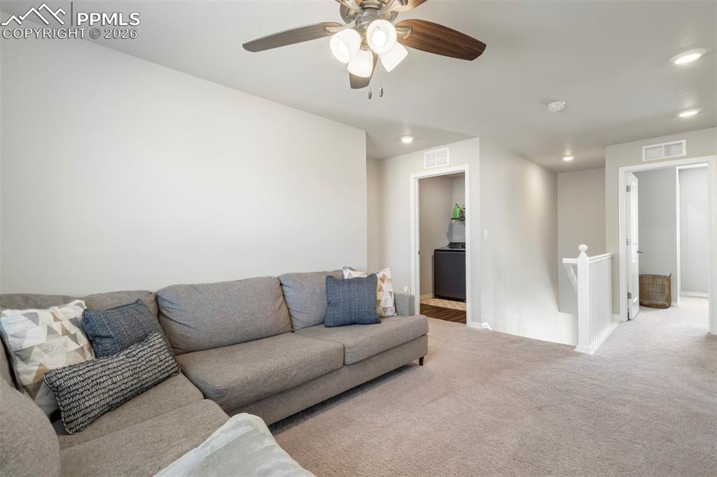 Image 23 of 46: Carpeted room featuring a ceiling fan with light fixture, recessed lighting