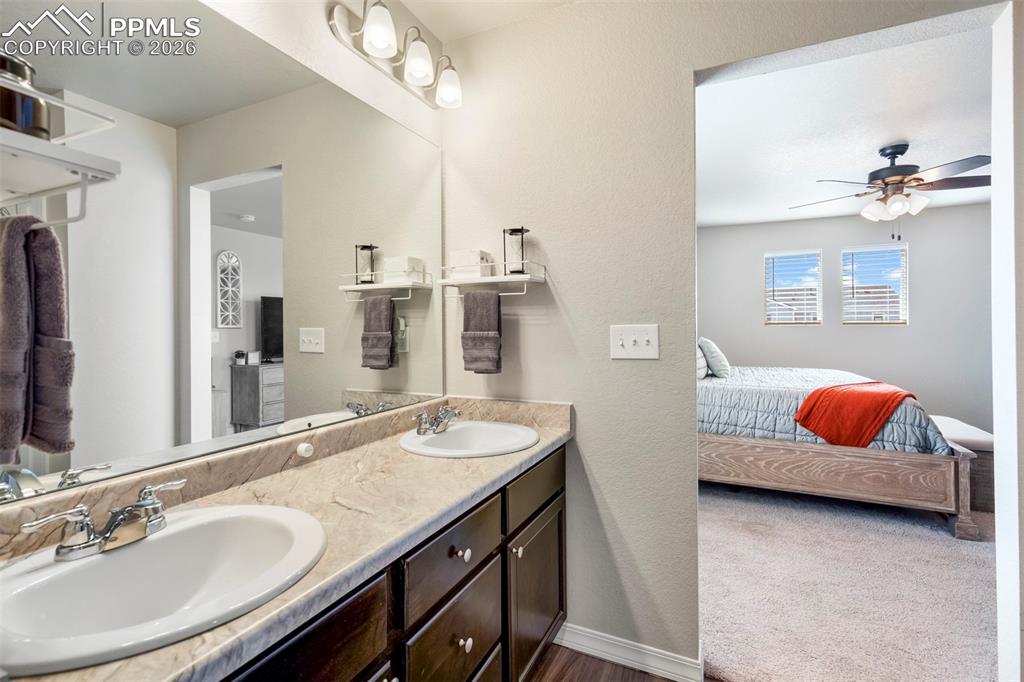 Image 28 of 46: Bathroom vanity featuring a dual sink design with chrome fixtures and a pat