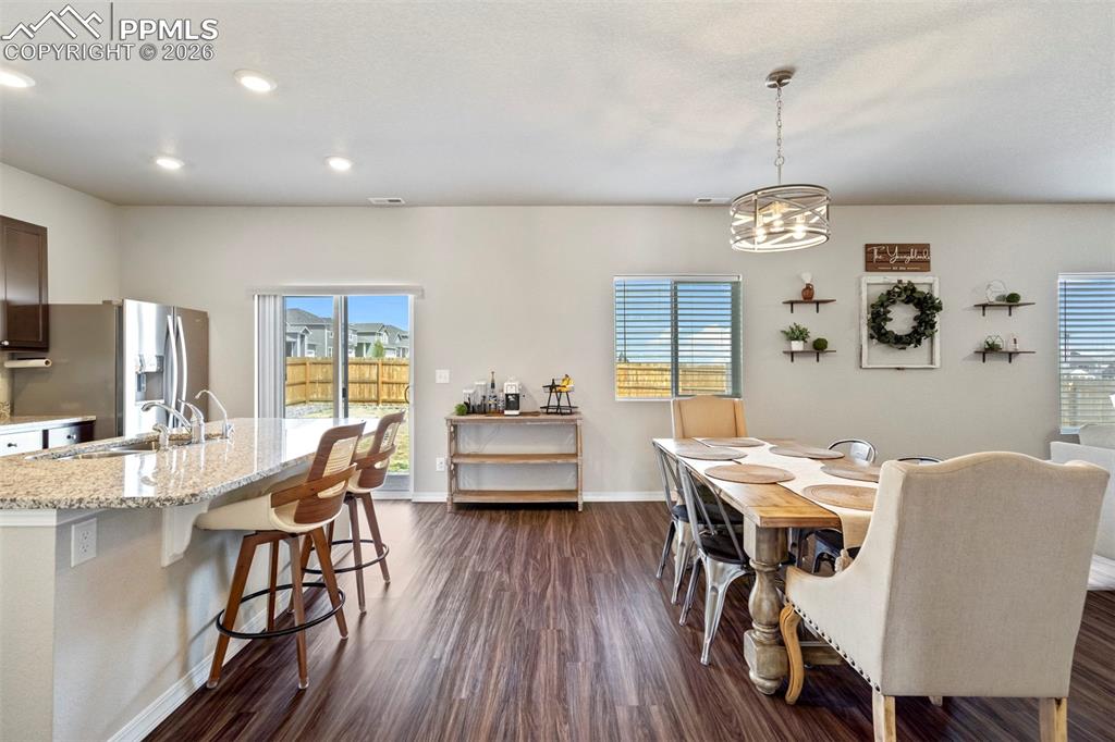 Image 4 of 46: Open-concept living space featuring wood-finish flooring, a kitchen island 