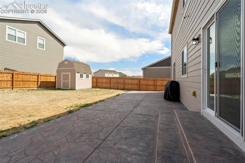 Image 40 of 46: Stamped concrete patio featuring a sliding glass door entry to the home