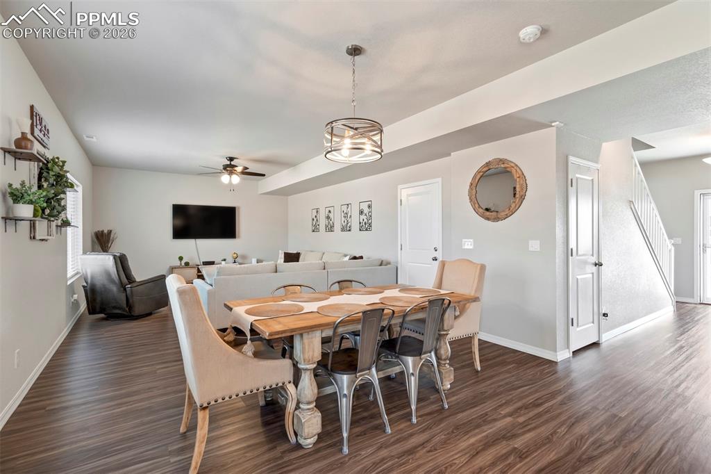 Image 9 of 46: Dining area featuring wood-finish flooring and a contemporary chandelier