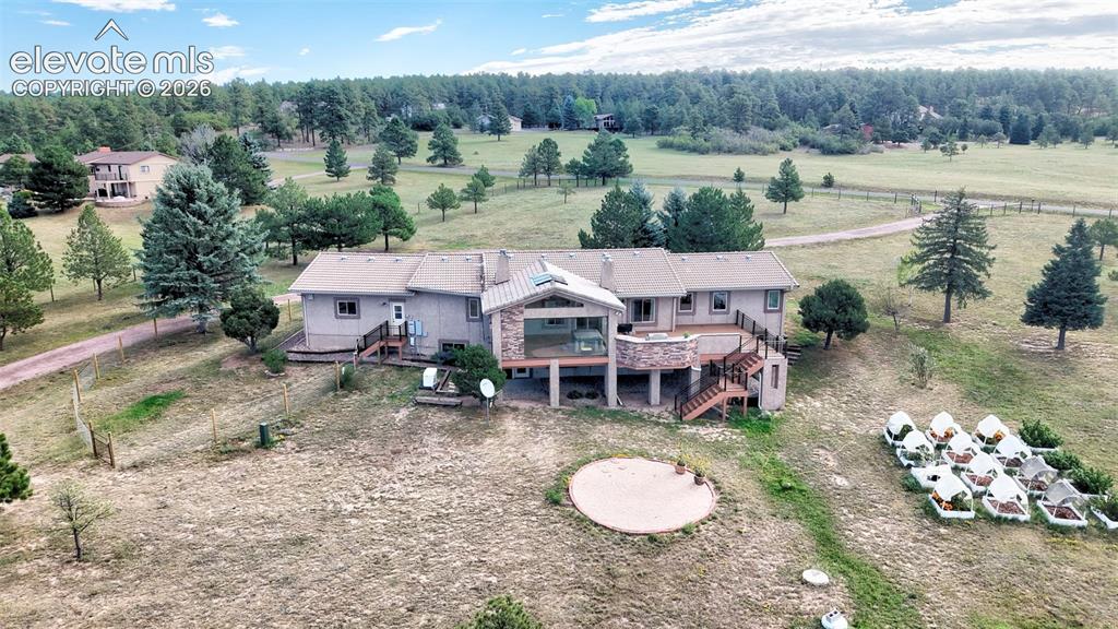 Caption: Ranch Home with gorgeous sunroom, expansive rear deck, fire pit, and raised garden beds.
