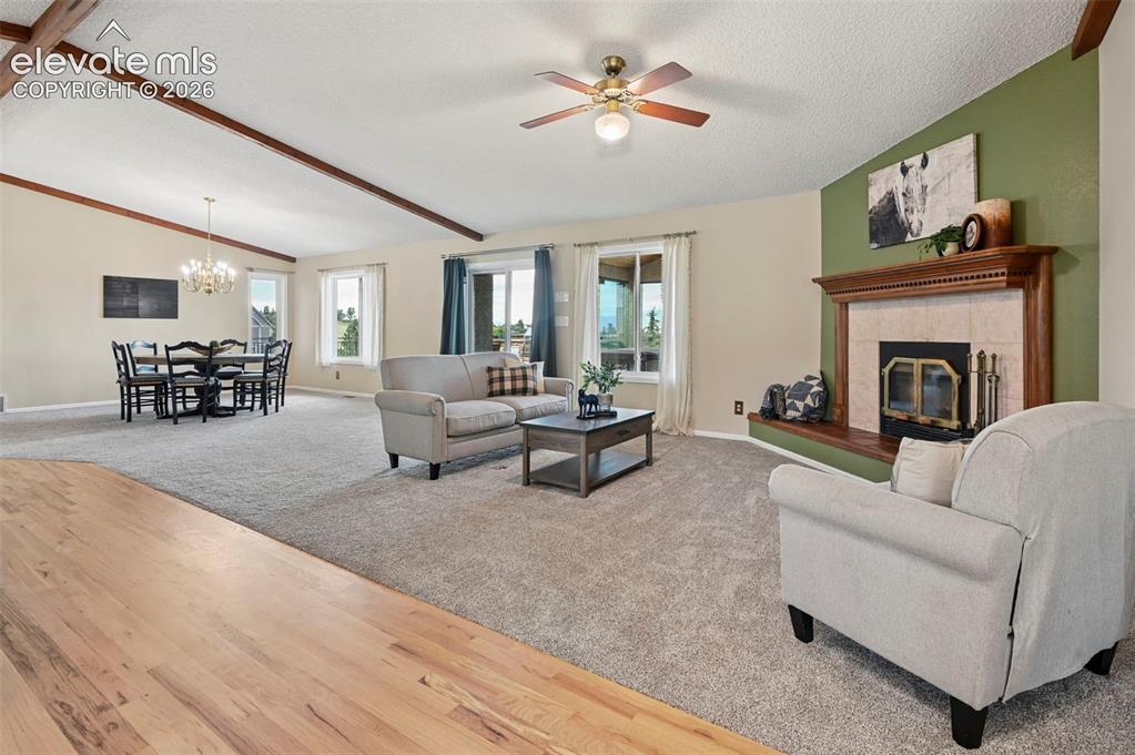 Image 12 of 50: Spacious Living area with wood burning fireplace