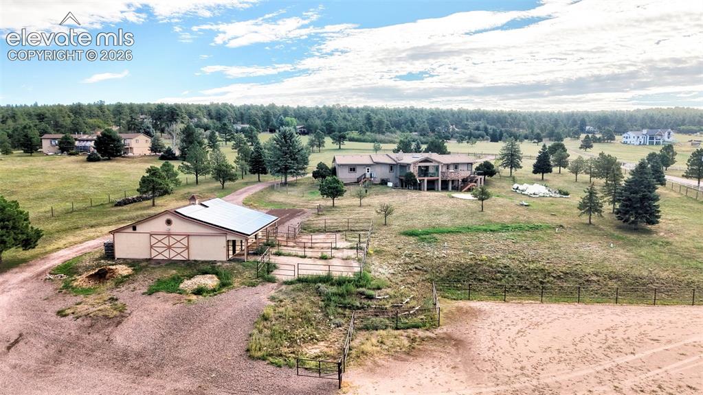 Image 41 of 50: Expansive property featuring a residence, barn, and multiple fenced areas