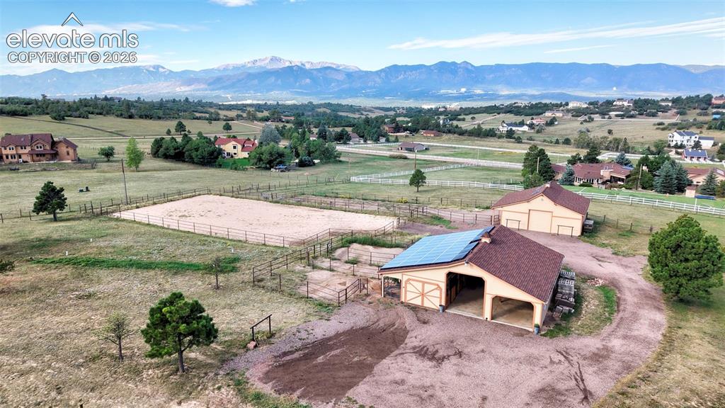 Image 48 of 50: Expansive property featuring a fenced riding arena, two outbuildings with t