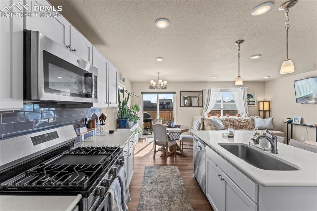 Image 10 of 37: Natural light fills the dining area, with direct access to the backyard for