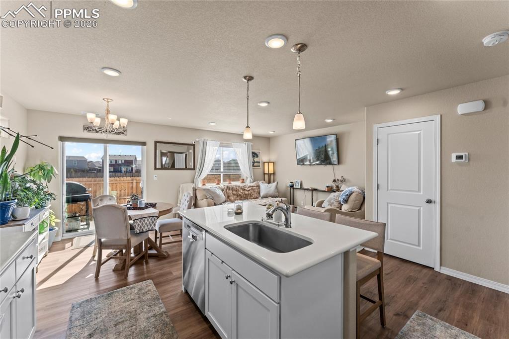 Image 11 of 37: The open layout connects the kitchen directly to the dining and living area