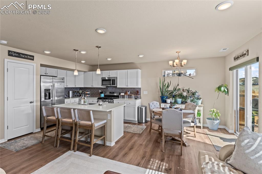 Image 12 of 37: Views from the living room flow seamlessly into the dining and kitchen area