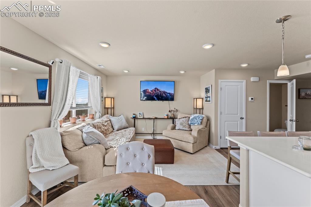 Image 13 of 37: The living room offers a comfortable setup with space for seating, media, a