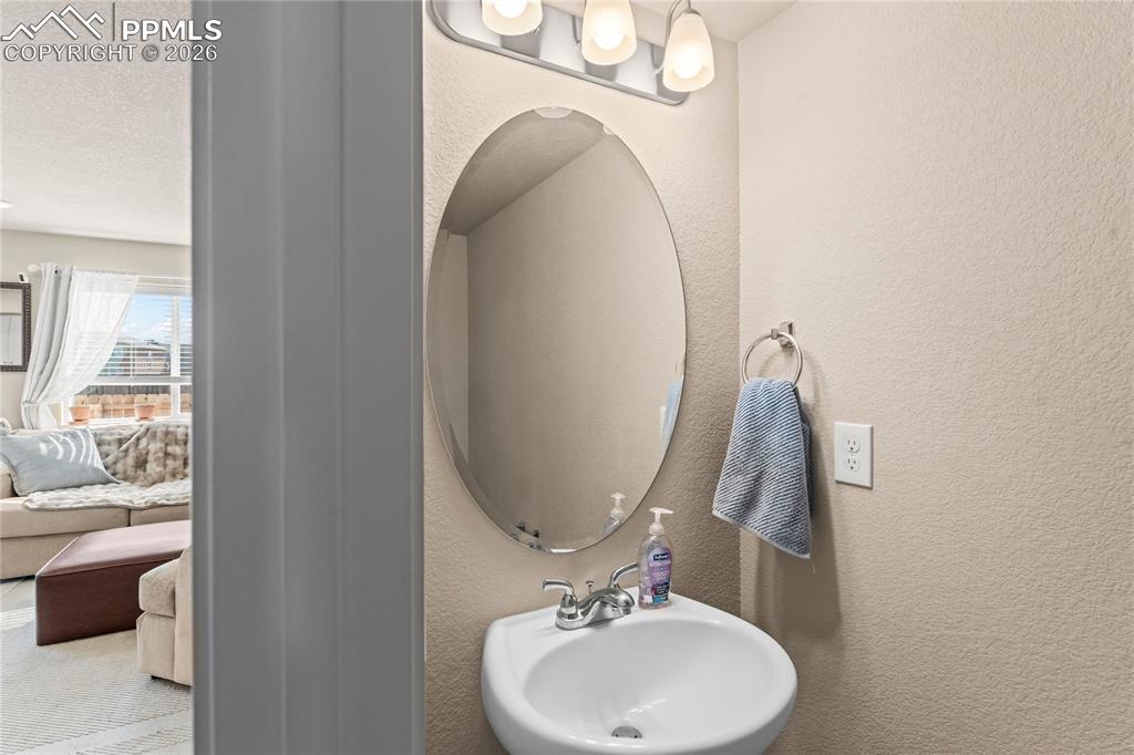 Image 17 of 37: A main-level powder bath adds convenience for guests without disrupting the