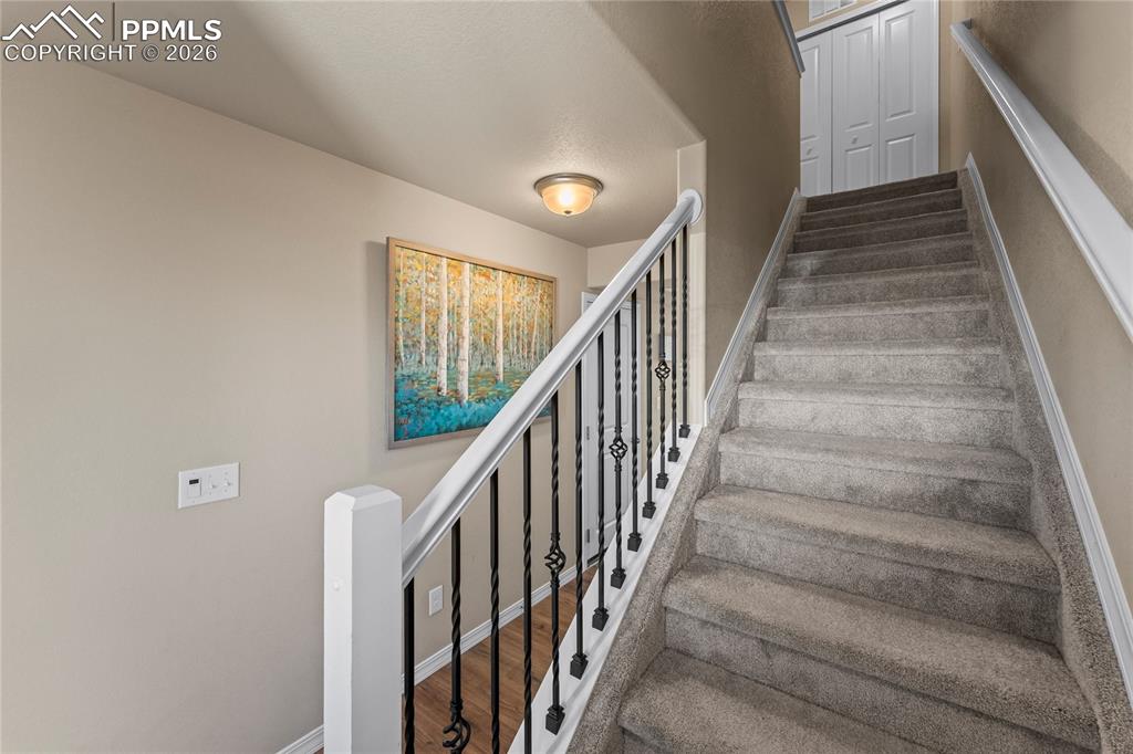 Image 18 of 37: The staircase pulls your eyes upward and gives the home a sense of movement