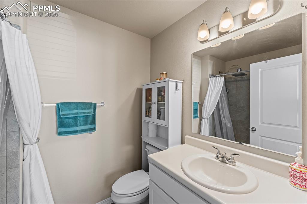 Image 22 of 37: The primary bathroom feels bright and functional, with a clean vanity setup