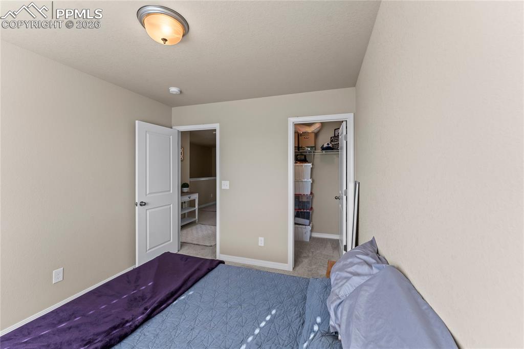 Image 26 of 37: Another view of the bedroom highlights the closet and easy access to the ha