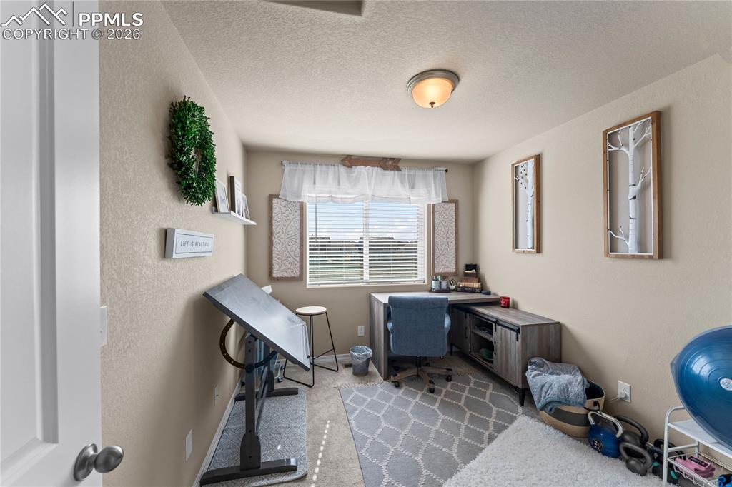 Image 27 of 37: This bedroom also works well as a home office or flex space, with natural l