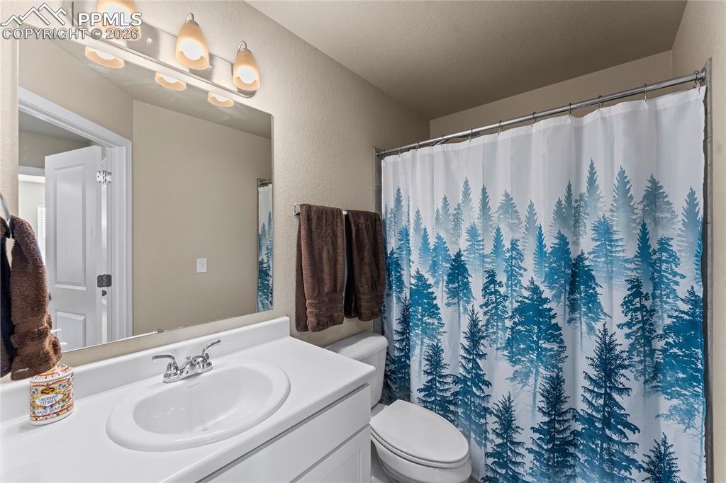 Image 30 of 37: This bathroom view highlights a full shower and simple, practical finishes
