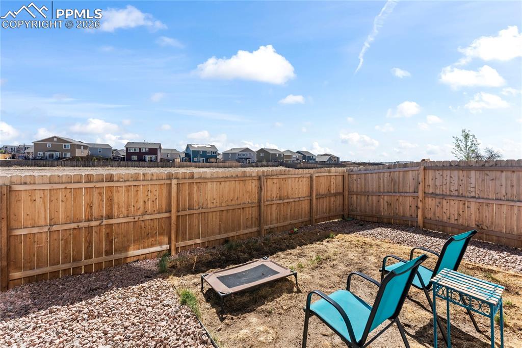 Image 31 of 37: The backyard is fully fenced, offering privacy and a secure space for pets