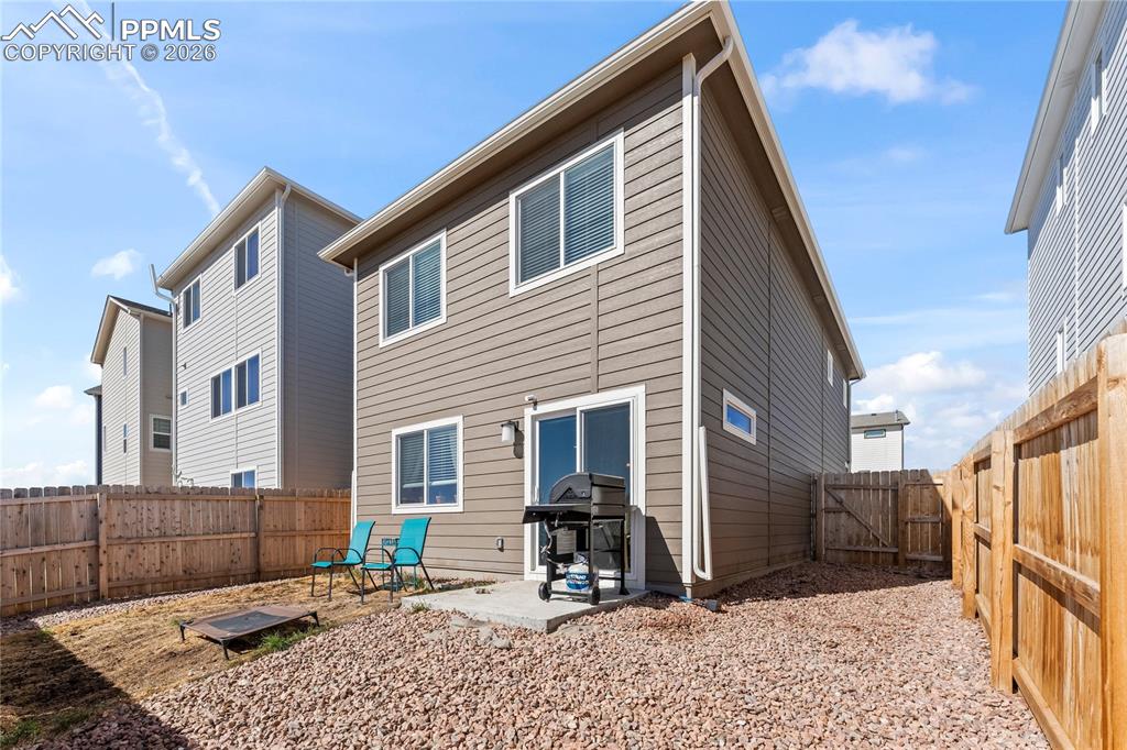 Image 33 of 37: A patio area just off the back door is perfect for grilling, relaxing, or c