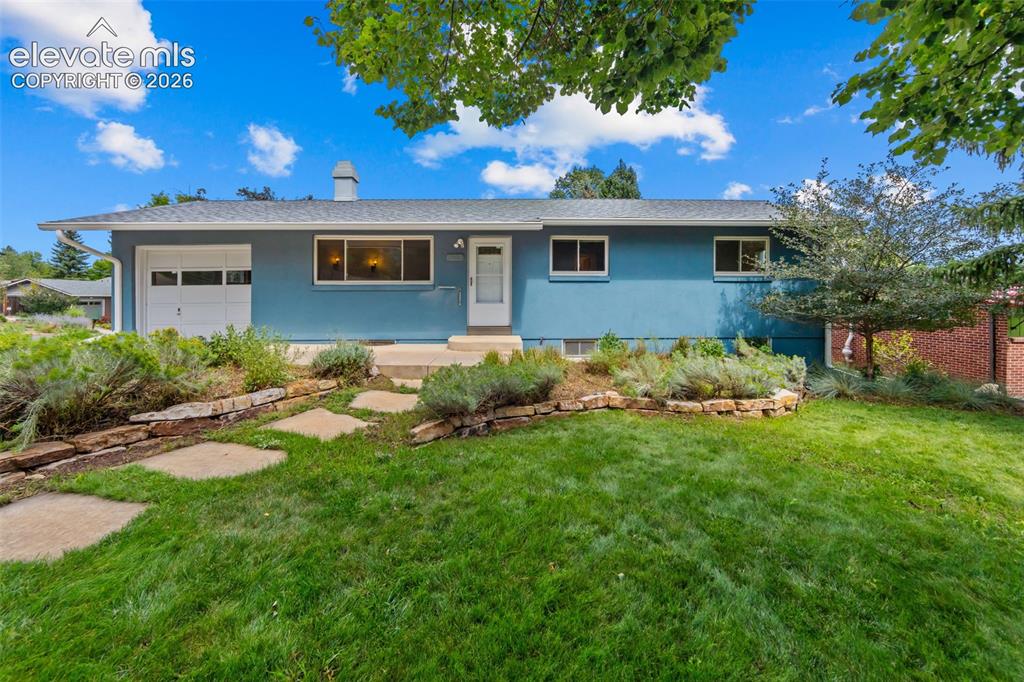 Caption: Beautifully landscaped home with maintenance free stucco
