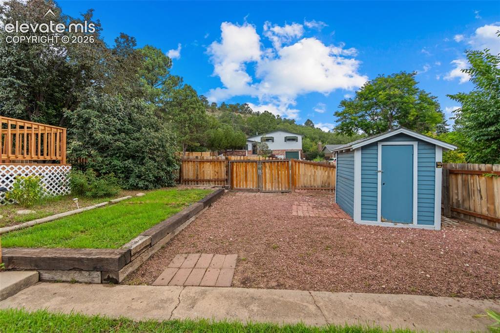 Image 18 of 28: Nice shed for yard tools. Could easily be made into RV parking
