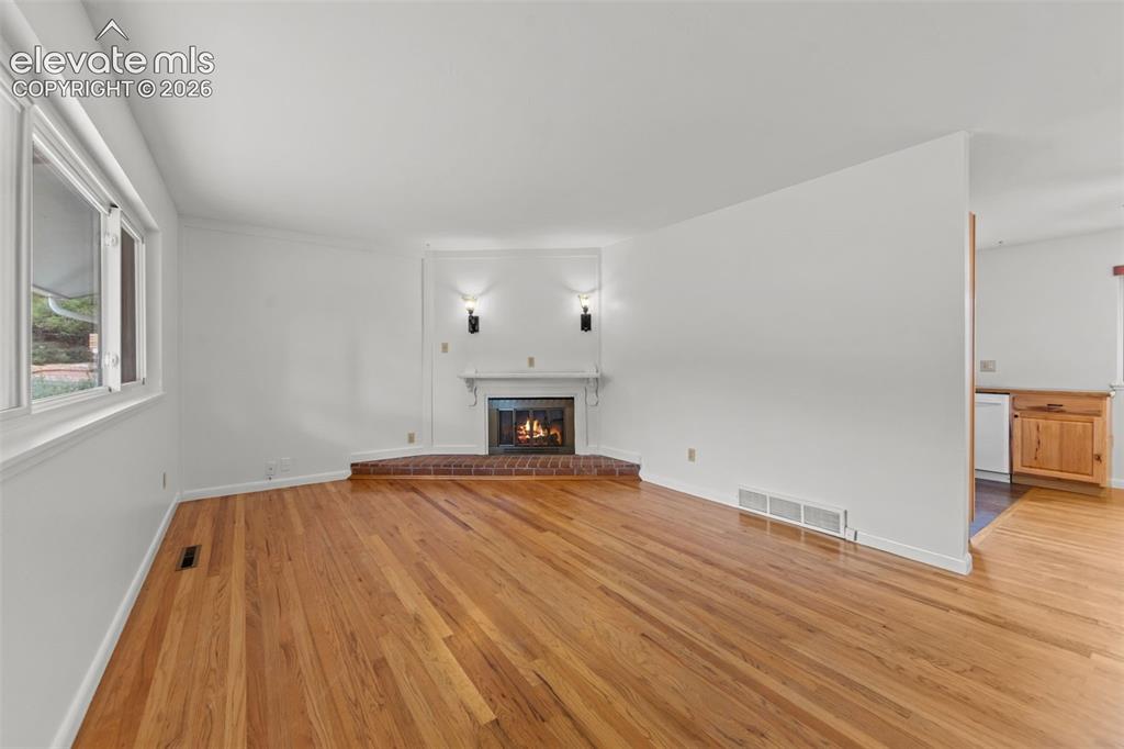 Image 2 of 28: Beautiful wood burning fireplace