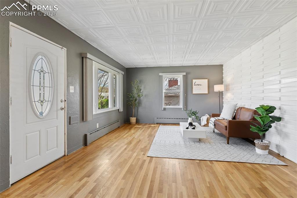 Image 10 of 37: Entrance foyer featuring an ornate ceiling, light wood-style flooring, and