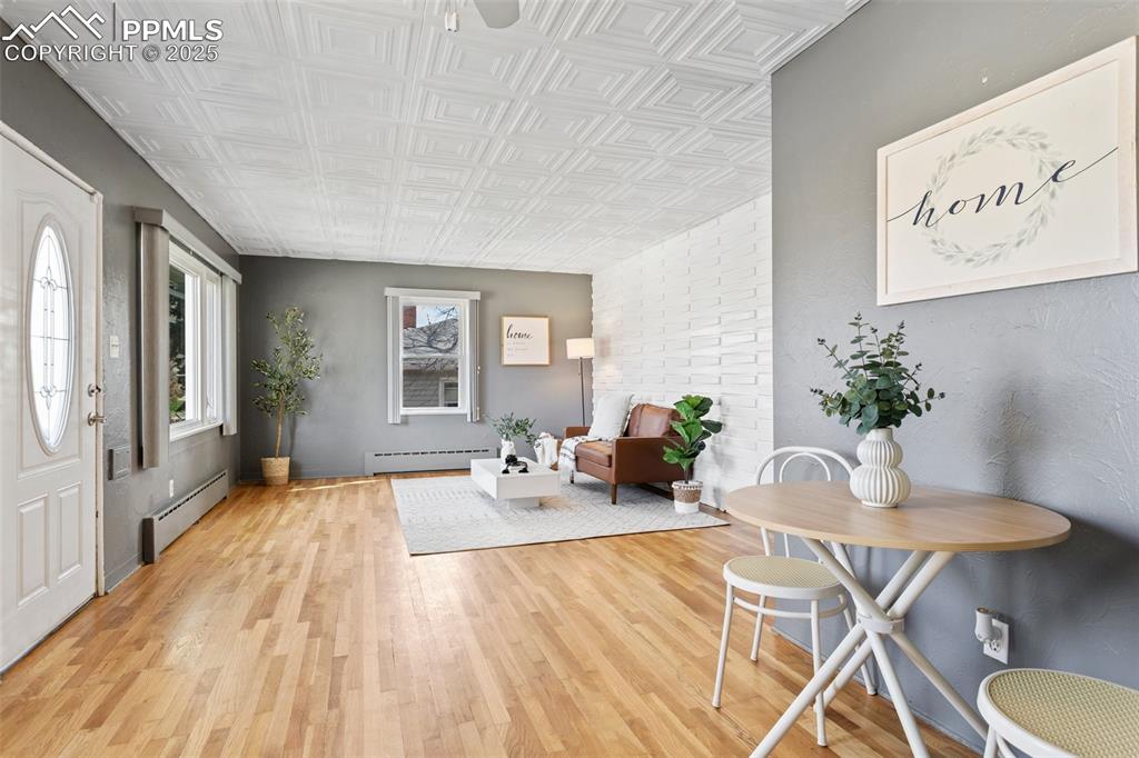 Image 12 of 37: Foyer entrance featuring a baseboard heating unit, light wood-style floorin