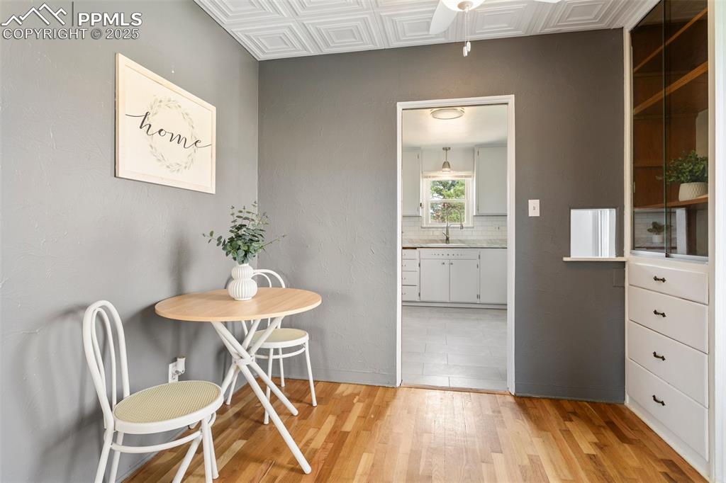 Image 13 of 37: Dining room with baseboards, an ornate ceiling, and light wood-style floors