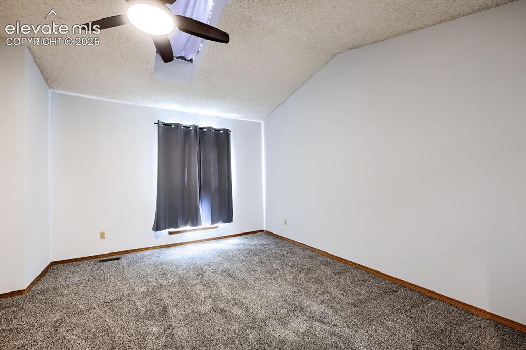 Image 11 of 23: Vaulted ceiling with an attached ceiling fan and light fixture