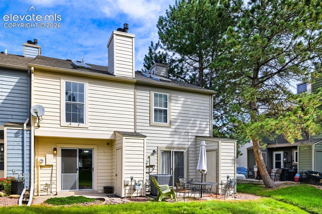 Image 21 of 23: Rear exterior with siding, sliding glass patio door, and an upper-level win