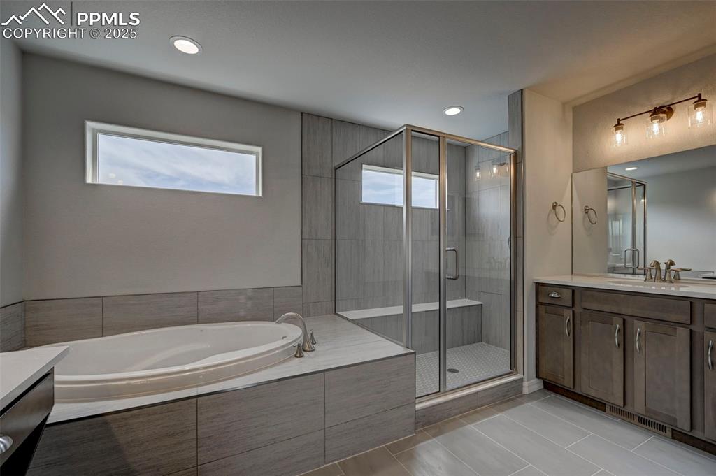 Image 16 of 23: primary bath with soaking tub and shower