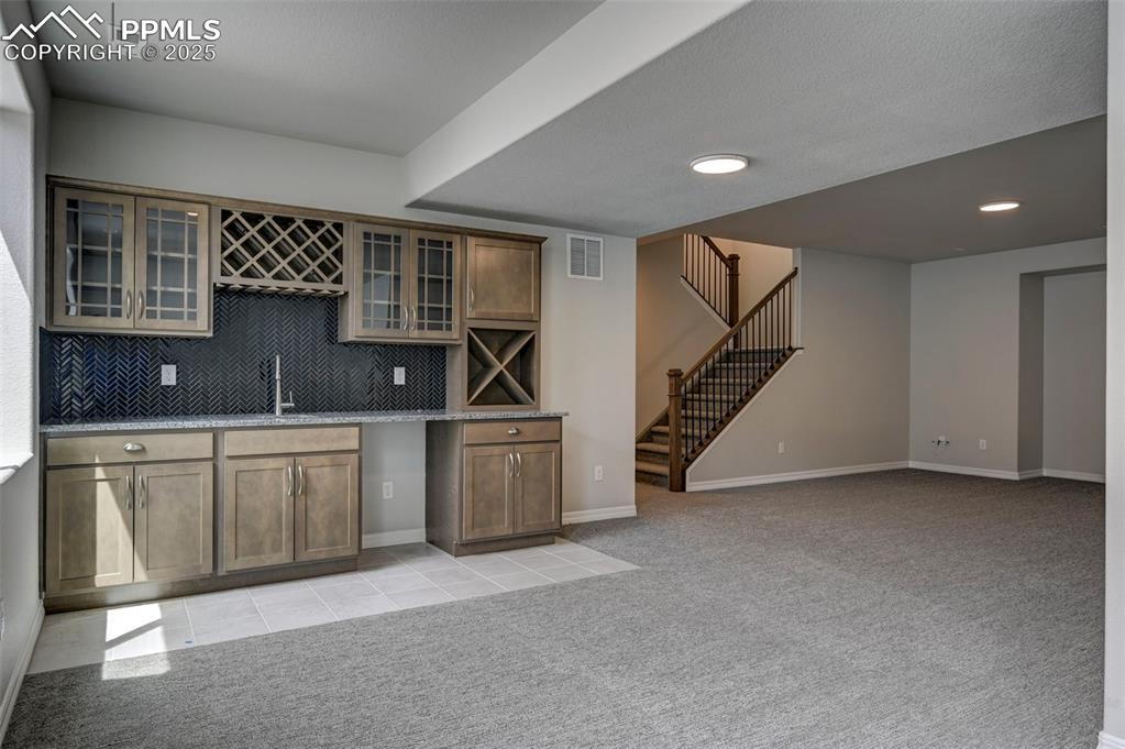 Image 20 of 23: Wine bar in finished basement with 9