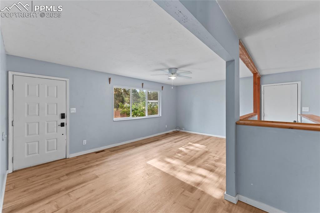Image 10 of 36: Entrance foyer featuring wood finished floors and a ceiling fan