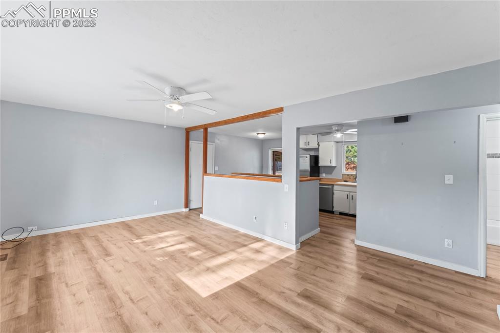 Image 5 of 36: Unfurnished living room featuring light wood-type flooring and ceiling fan