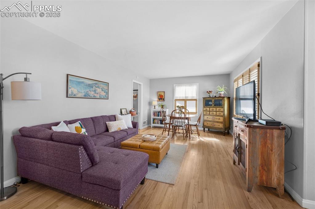 Image 6 of 28: Living room and dining area. Wooden window blinds in the living room, dinin