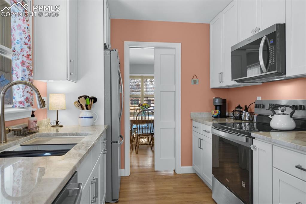 Image 8 of 28: There is a pocket door seperating the dining area and the kitchen