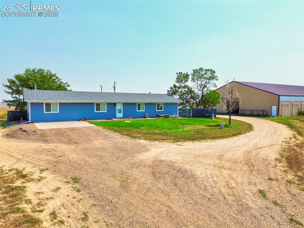 Image 38 of 43: Ranch-style home with driveway and a patio