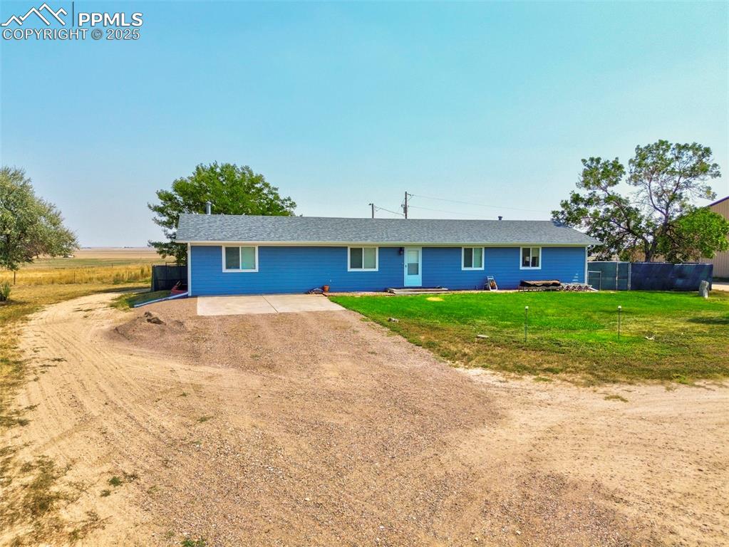 Image 39 of 43: View of front facade with a patio area and driveway