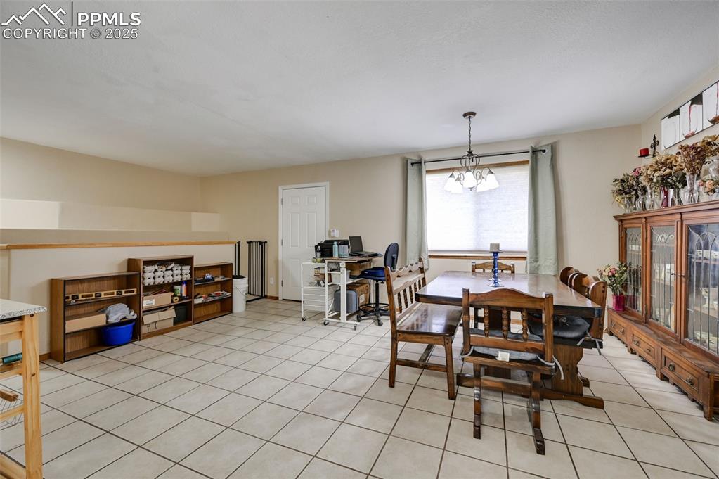Image 4 of 43: Dining space featuring light tile patterned flooring, a chandelier, and an 